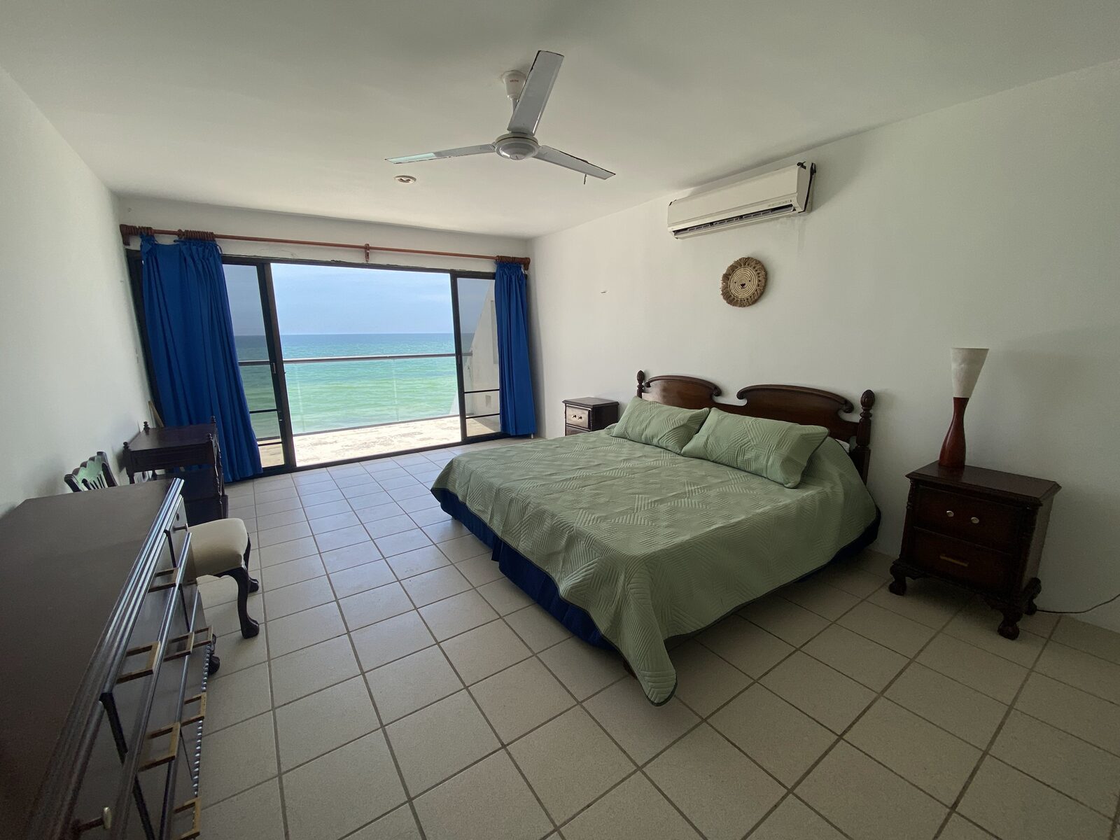 Recámara con vista al mar y cortinas azules